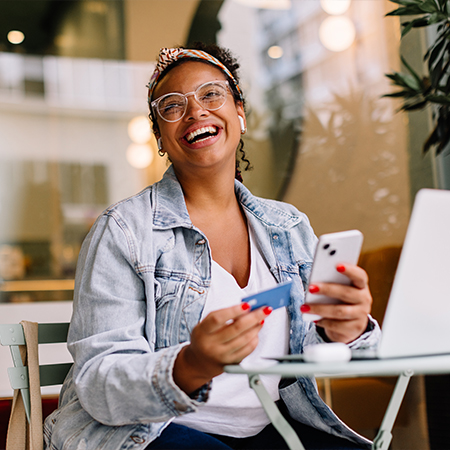 woman with mobile ohone abd bank card Online Banking